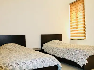 two beds sitting next to each other in a bedroom at Douceur de Vie in Praia