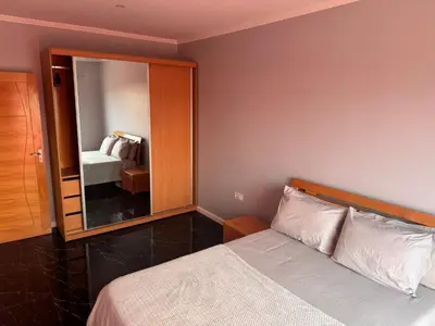 a bedroom with a bed and a large mirror at Apartamento mais Carro George Mendes in Praia