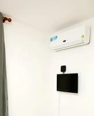 a room with a air conditioner on the ceiling at Sea Breeze Apartment in Santa Maria