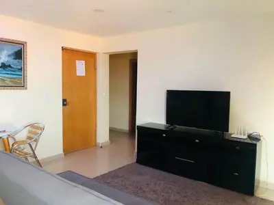 a living room with a flat screen tv on a dresser at PJ t1 conforto e paz 4E in Praia
