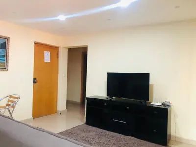 a living room with a flat screen tv on a dresser at PJ t1 conforto e paz 4E in Praia