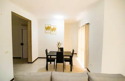 a dining room with a table and chairs at Cozy and beautiful apartment! in Praia