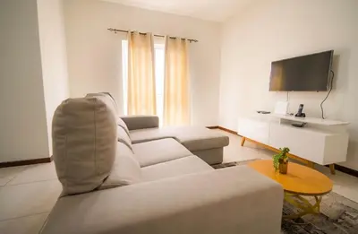 a living room with a couch and a tv at Cozy and beautiful apartment! in Praia