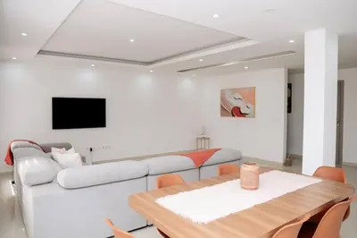 a living room with a couch and a table at Spacious 3-Bedroom Apt Near Kebra Kanela Beach in Praia