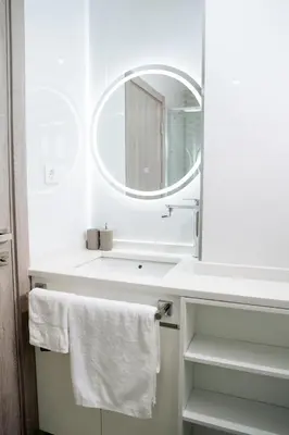 a bathroom with a white sink and a mirror at Spacious 3-Bedroom Apt Near Kebra Kanela Beach in Praia