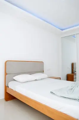 a white bedroom with a bed with white sheets at Spacious 3-Bedroom Apt Near Kebra Kanela Beach in Praia