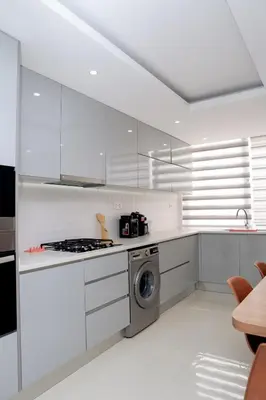 a white kitchen with a stove and a dishwasher at Spacious 3-Bedroom Apt Near Kebra Kanela Beach in Praia