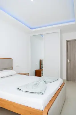 a white bedroom with a bed with white sheets at Spacious 3-Bedroom Apt Near Kebra Kanela Beach in Praia
