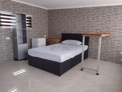 a bedroom with a bed with a wooden table at Moreira Estates