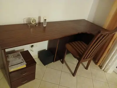 a wooden desk with a chair and a telephone at Paraiso 162E in Santa Maria