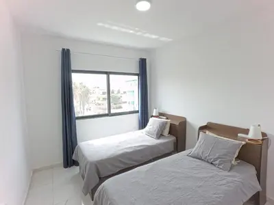 two beds in a room with a window at Casa Emilie T2, 2 bedrooms in Santa Maria