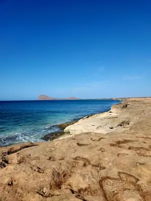 a view of the ocean from a rocky beach at Casa Emilie T2, 2 bedrooms in Santa Maria