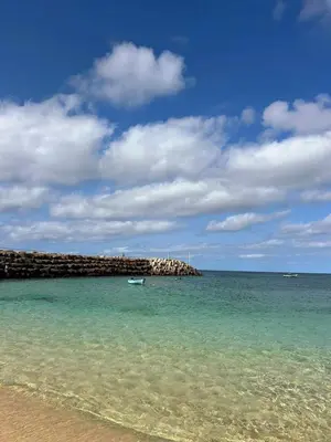 a beach with a small boat in the water at Casa Emilie T2, 2 bedrooms in Santa Maria