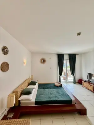 a bedroom with a large bed in a room at Studio with pool in Santa Maria