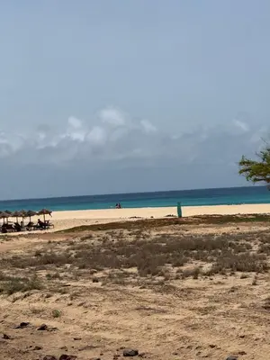 an empty beach with umbrellas and the ocean at Studio with pool in Santa Maria