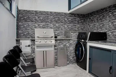 a kitchen with a stove and a washing machine at N3XT-LEVEL Pool in Praia