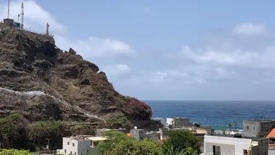 a view of a mountain next to the ocean at Alfa-Rooms in Paul