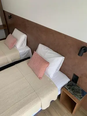 a room with two beds and a side table at Alfa-Rooms in Paul