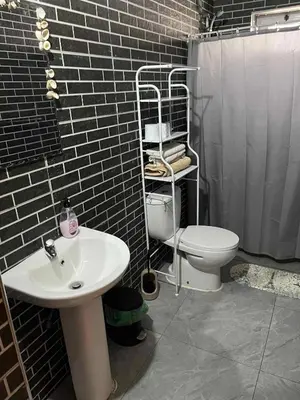 a bathroom with a white sink and a toilet at Pousada Aguia in Praia