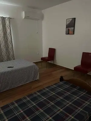 a bedroom with two red chairs and a bed at Pousada Aguia in Praia
