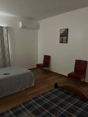 a bedroom with two red chairs and a bed at Pousada Aguia in Praia