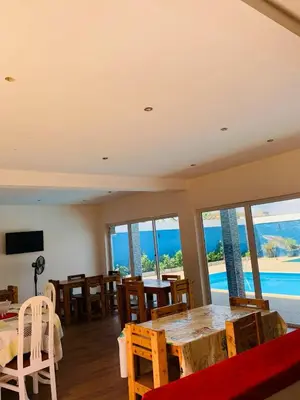 a dining room with a table and a view of the ocean at Pousada Aguia in Praia