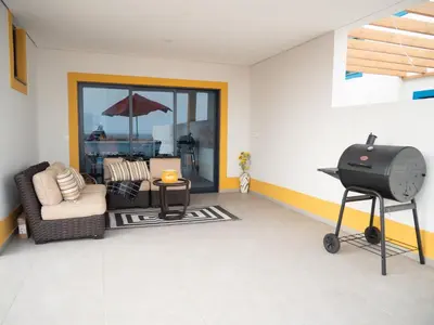 a living room with a grill and a patio at Blue Coast Villas - Villa 6 in Cidade Velha