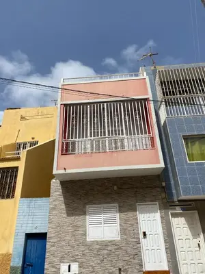 a building with a balcony on the side of it at Apartamento em Monte in Mindelo