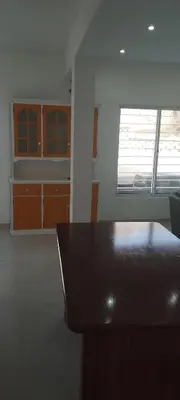 a kitchen with a wooden table in a room at Mira Mar Mindelo in Mindelo