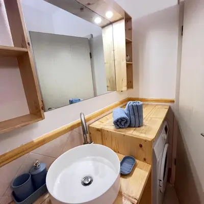 a bathroom with a white sink and a mirror at Urban Studio Plaza 6 in Santa Maria