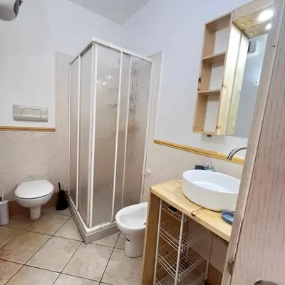 a bathroom with a shower and a toilet and a sink at Urban Studio Plaza 6 in Santa Maria