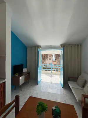 a living room with a door open to a patio at Murdeira V17 I by RPG Group in Beirona