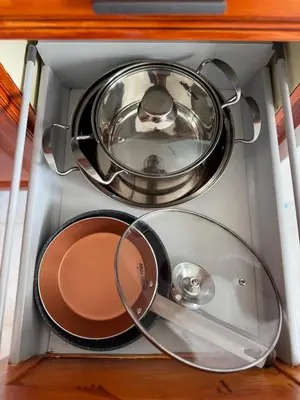a stove with two pans and a pot in a drawer at Murdeira V17 I by RPG Group in Beirona