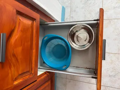 a blue fan sitting in the corner of a cabinet at Murdeira V17 I by RPG Group in Beirona