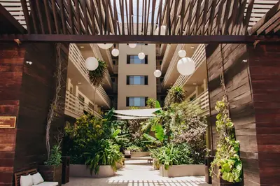 an indoor courtyard with plants in a building at Pôr D'Sôl Mindelo in Lazareto