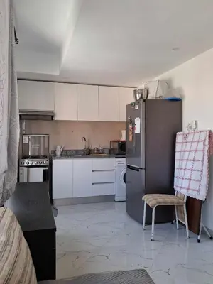 a kitchen with white cabinets and a refrigerator at Casa da Sara Guest House in Mindelo