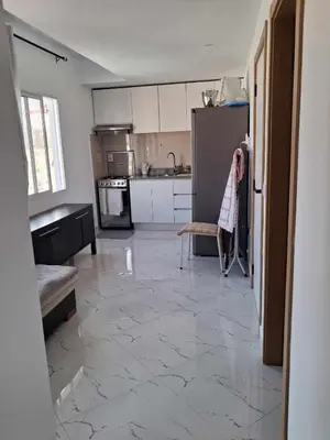 a woman standing in a kitchen with a tile floor at Casa da Sara Guest House in Mindelo