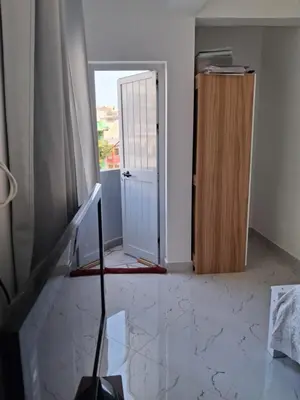 an empty room with a door and a window at Casa da Sara Guest House in Mindelo