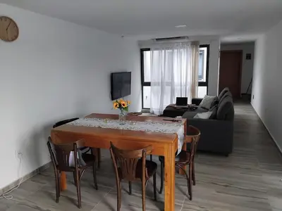 a living room with a wooden table and chairs at Quinta Achada Fazenda in São Tiago