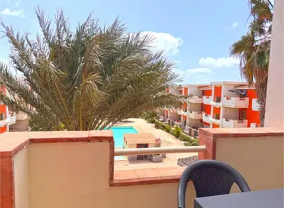 a balcony with a view of a pool and buildings at Morabeza Santa Maria - Djadsal Moradias in Santa Maria
