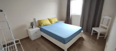 a bedroom with a bed and a chair and a window at Sams House in Espargos
