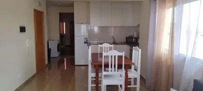 a kitchen with a table and chairs and a refrigerator at Sams House in Espargos