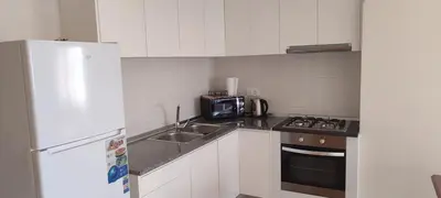a small kitchen with a sink and a microwave at Sams House in Espargos