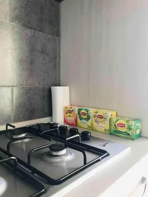 a stove top with two containers of food on a counter at Kite & Chill Sal Rei in Sal Rei