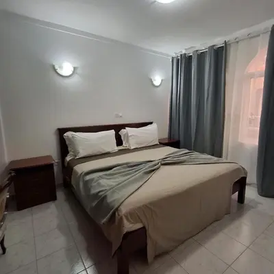 a bedroom with a large bed with two pillows at HOSTEL Terra Branca in Praia