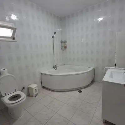 a bathroom with a tub and a toilet and a sink at HOSTEL Terra Branca in Praia