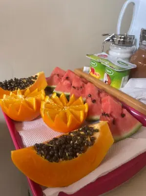 a tray filled with slices of watermelon and fruit at HOSTEL Terra Branca in Praia