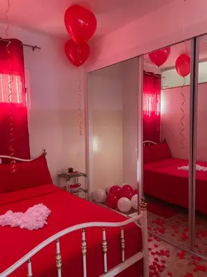 a bedroom with red balloons hanging from the ceiling at HOSTEL Terra Branca in Praia