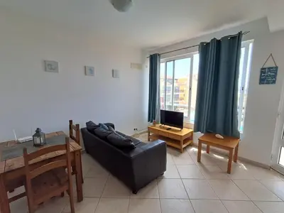 a living room with a couch and a table at Boa Vista BriMar Holidays, apartamento with pool in Rabil
