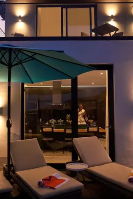 a living room with two chairs and an umbrella at CORAL BAY - Kode Villa in Cidade Velha